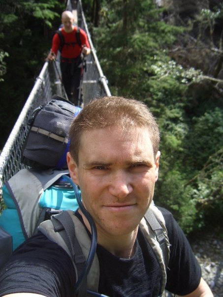 Global Therapies: Tim crossing a bridge on West Coast Trail, Vancouver Island, Canada
