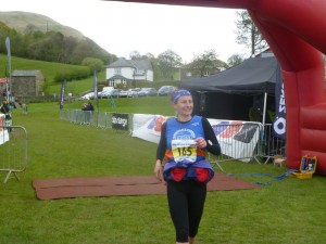 Smiling on the finish line of my first ever marathon, the Howgills Montane Trail 26 